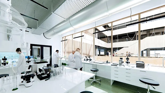 The illustration shows people working in a laboratory setting.